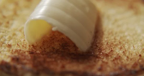 Macro shot of butter melting on half burger bun. Slow motion video Stock Footage 116245106