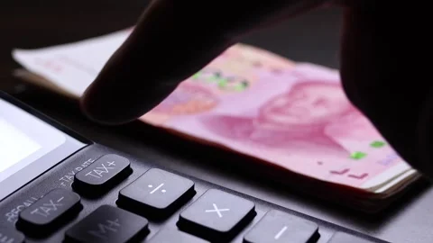 Macro shot of calculator and Chinese Yuan (CNY) banknotes. Stock Footage 304498877