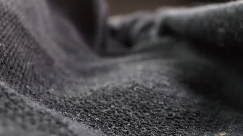 Macro shot of a camera gliding over fabric, with the weave and folds illumi.. Stock Footage 260223201
