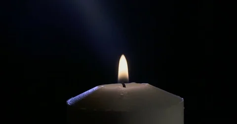 Macro shot of a candle blown out with smoke rising from wick Stock Footage 74349905