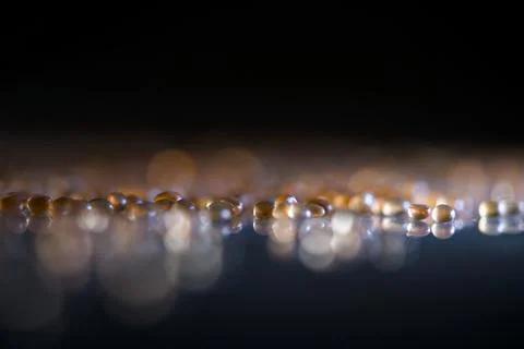 Macro shot capturing shimmering droplets on shiny surface Stock Photos