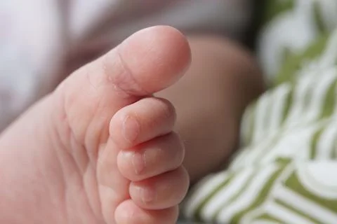 Macro shot capturing the tiny, soft skin of a newborn baby's foot 스톡 사진