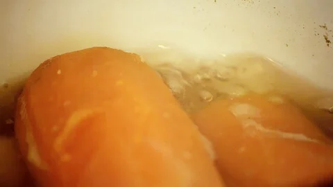 Macro Shot of Carrots Boiling Stock Footage 100071420