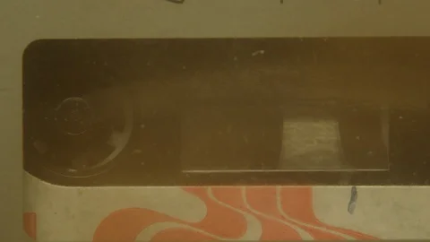 A macro shot of a cassette spinning. Video stock 120461858