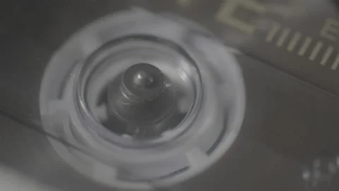 Macro shot of cassette tape in deck spinning Stock Footage 146858041