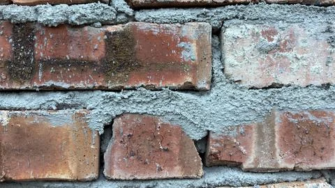 Macro Shot Of Cement Mortar Between Red Bricks In New House Construction Stock Photos