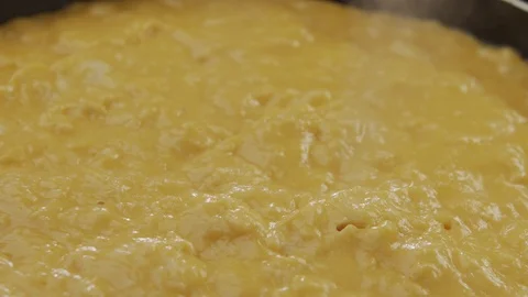 Macro shot of cheese melt in hot pan. Melted cheese blows bubbles with steam Video stock 120401270