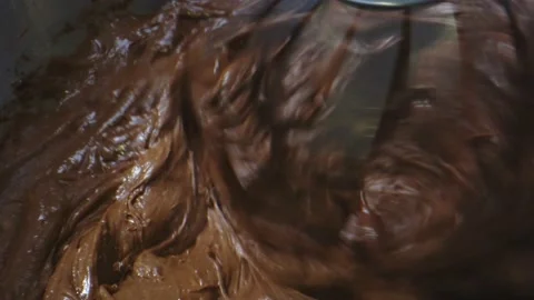 Macro shot of chocolate cake ingredients being mixed in food mixer Stock Footage 131689971
