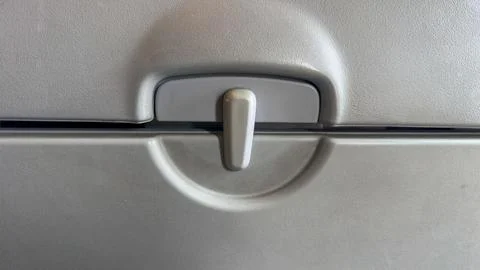 Macro shot of a circular latch on a car trunk lid, highlighting the handle an Photos
