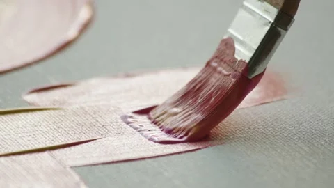 Macro shot close up of brush with yellow-pink paint that glides across canvas Stock Footage 224607173