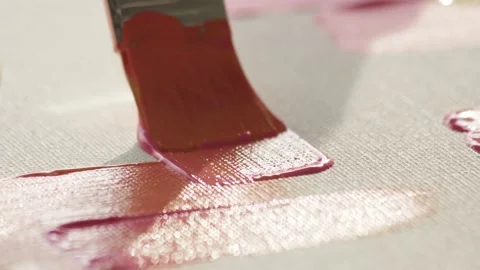 Macro shot close up of brush with yellow-pink paint that glides across canvas Stock Footage 224607715
