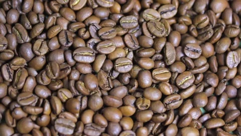 Macro shot of coffee beans that rotate on a plate Video stock 155888462