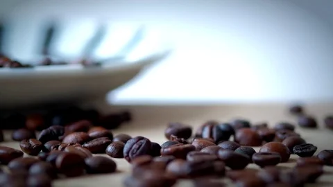 Macro shot of coffee cup filled with coffee beans on wooden table. Stock Footage 72367212