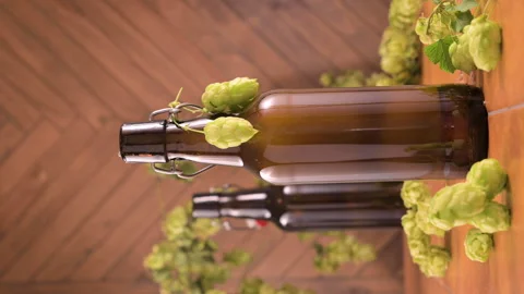 Macro shot of a cold brown beer bottle with a droplet of condensation slowly Stock Footage 311817249