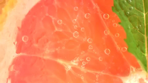 Macro shot of cold refreshing grapefruit lemonade with ice cubes and mint. Stock Footage 281270289
