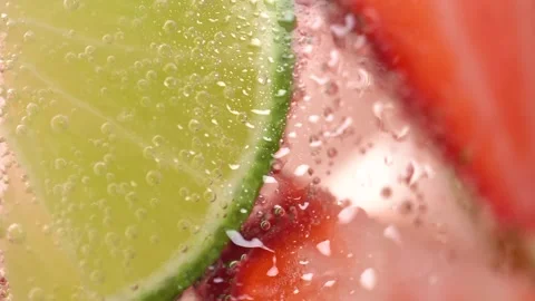 Macro shot of cold refreshing strawberry and lime lemonade with ice cubes. .. Stock Footage 275882067
