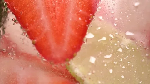 Macro shot of cold refreshing strawberry and lime lemonade with ice cubes. .. Stock Footage 276893339