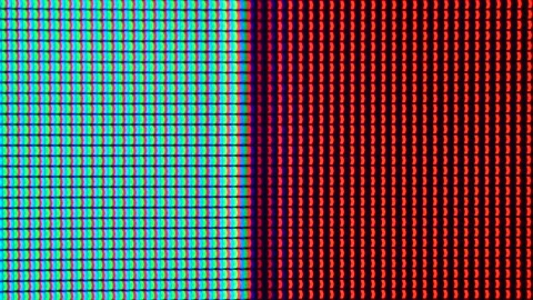 Macro shot of a computer display or TV screen. Multi-colored pixels as trace  Stock Footage 135027123