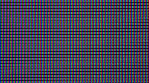 Macro shot of a computer display or TV screen. Multi-colored pixels as trace  Stock Footage 136509396