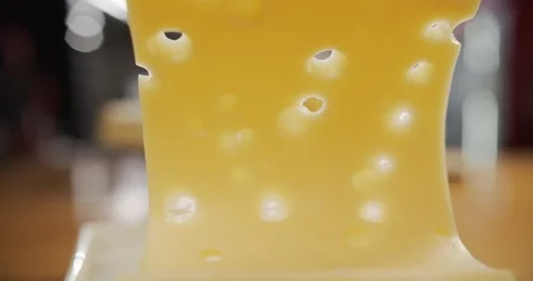 Macro shot the cook throws slice of cheese with holes on the board Video stock 120456685