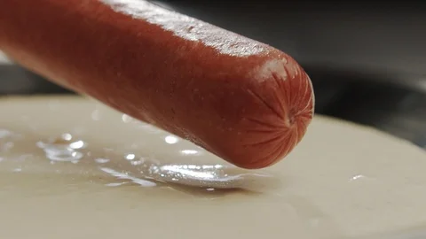 Macro shot cooking corn dog, sausage dipped in life-long dough Stock Footage 117471342