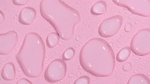 Macro Shot of Cosmetic moisturizing drops of liquid on a pink pastel background Stock Footage 168963102