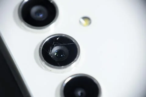 Macro shot of a cracked and broken smartphone camera lens Stock Photos