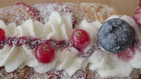 Macro Shot of a Delicious Berry Cake with Whipped Cream and Powdered Sugar Stock Footage 334907570