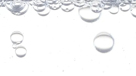Macro Shot of Different Sized Clear Air Bubbles in Clear Water Rising up on Stock Footage 264578694