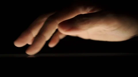 Macro shot of digital gadget user using touch screen tablet in the dark Stock Footage 121325260