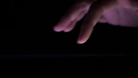 Macro shot of digital gadget user using touch screen tablet in the dark Stock Footage 121325265