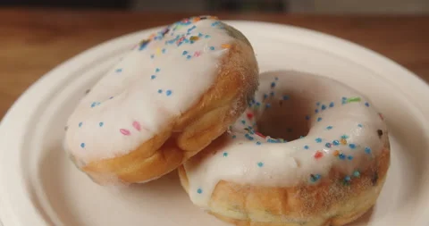 Macro shot of a donut with colored icing but spoiled, expired, covered in green Stock Footage 262002267