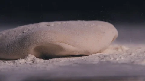 A macro shot of a dough that is thrown against a dark background. Stock Footage 112652884