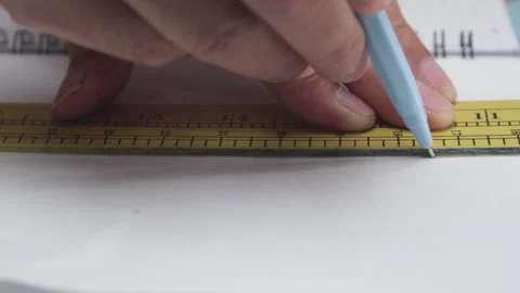 Macro Shot of Drawing a Straight Line with a Pen and Ruler on White Paper Stock Footage 337880783
