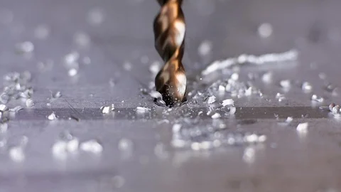 Macro shot of a drill that pierces a sheet of iron or steel. Stock Footage 118389878