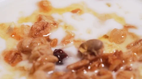 Macro shot - drop of mountain honey for granola and yogurt. The concept of a Stock Footage 126213064