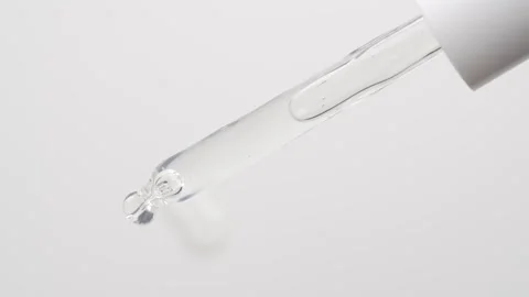 Macro shot of drop serum gel of is falling down from pipette Stock Footage 248508369