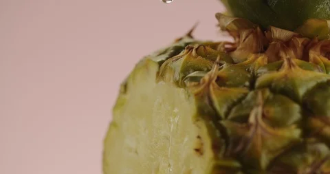 Macro shot of drop of water falling on pineapple. 4K Slow Motion Stock Footage 125031869
