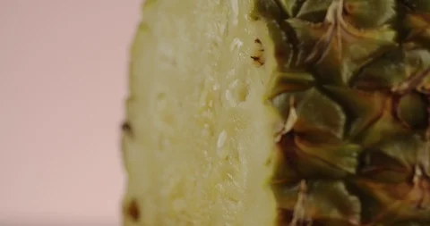 Macro shot of drop of water flowing down pineapple. 4K Slow Motion Stock Footage 125123286