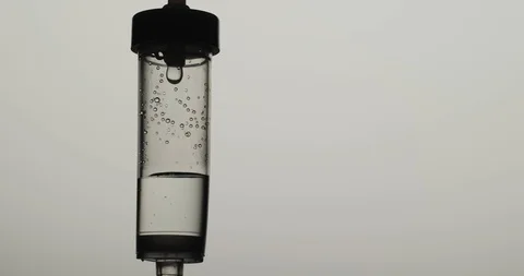 Macro shot: Dropper. Liquid or saline slowly dripping in left corner of frame Stockbeeldmateriaal 126159188