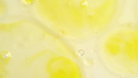 Macro shot of drops of orange essential oil  in water, rotate, top view.  C.. Stock Footage 273678124