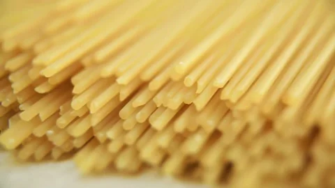 Macro shot of dry spaghetti pasta ends on table Video stock 333836570
