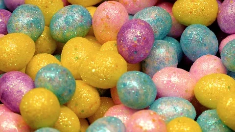Macro shot of easter eggs tumbling into basket filling frame Stock Footage 87691876