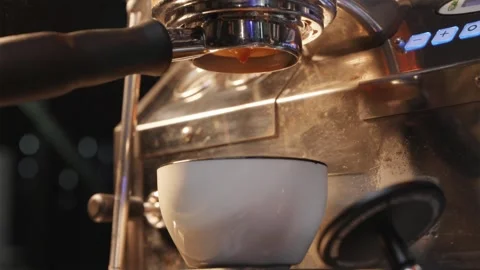 Macro shot of espresso pouring into a cup in slow motion Stock Footage 334732434