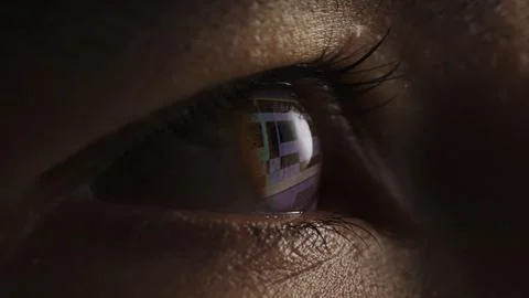Macro shot of eyes with program for video editing reflection. Video processing 스톡 사진