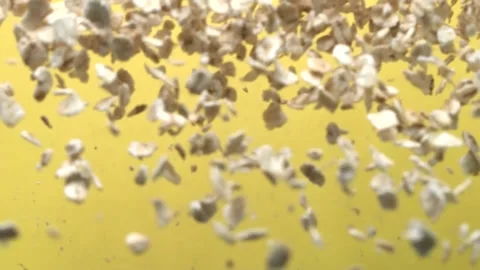 Macro shot of falling oatmeal on yellow background Stock Footage 151085461
