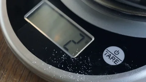 Macro Shot of a Female Baker Turning on a Digital Kitchen Scale - 4K Stock Footage 76591997
