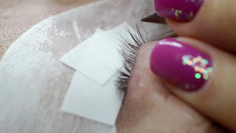 Macro shot of a female eye in the process of eyelash extension. Stock Footage 163060948