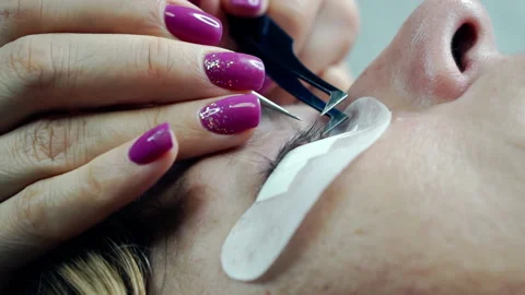 Macro shot of a female eye in the process of eyelash extension. Stock Footage 163061236