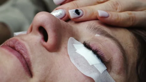 Macro shot of a female eye in the process of eyelash extensions. Stock Footage 171854016